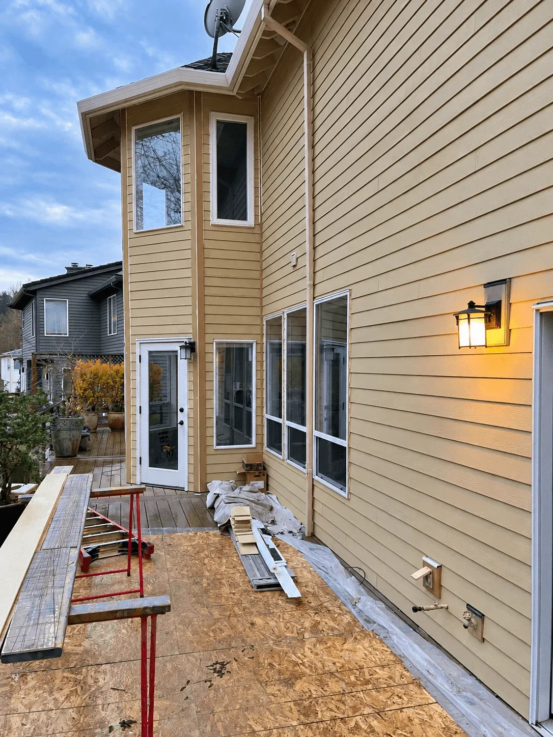 New sliding doors and siding along a deck under construction
