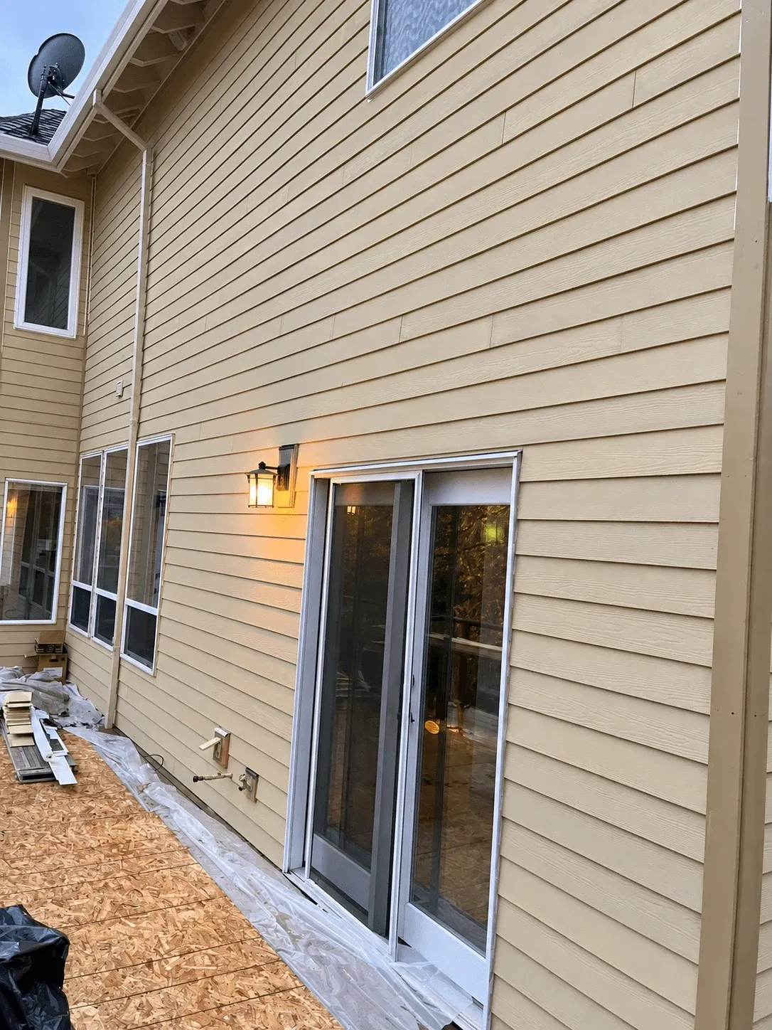 Deck subfloor beside a new sliding door at the back of a home