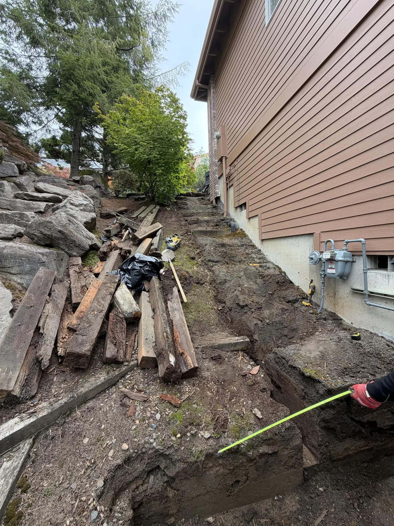 Excavated slope and measured layout for the stair rebuild