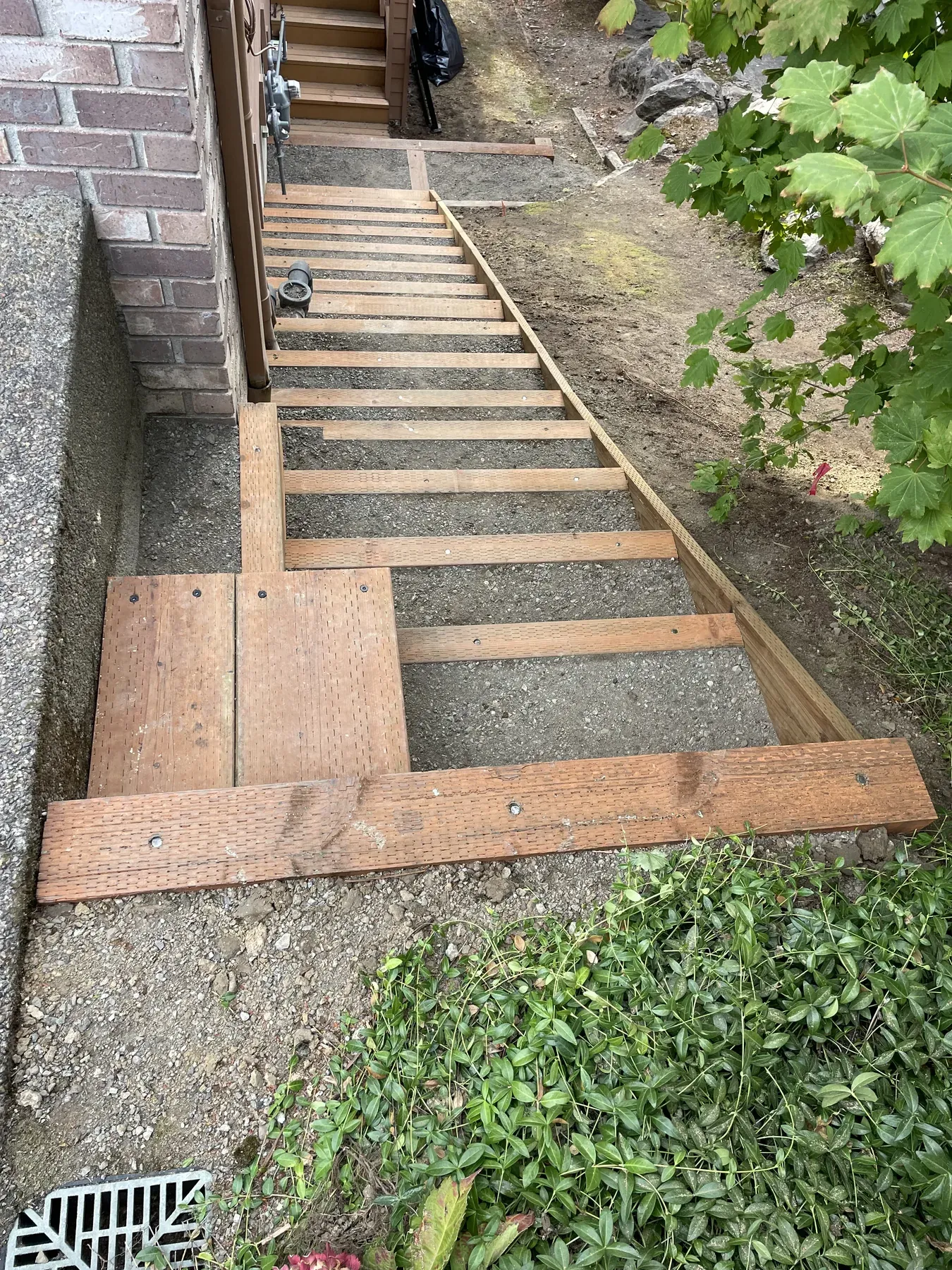 New stair stringers installed beside the existing deck