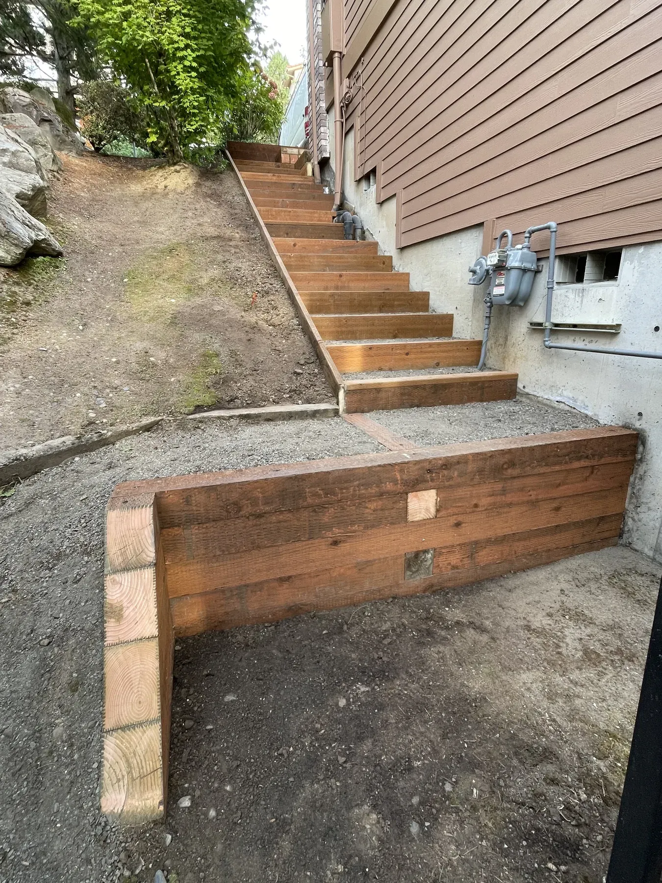Outdoor staircase framing and retaining wall work in progress