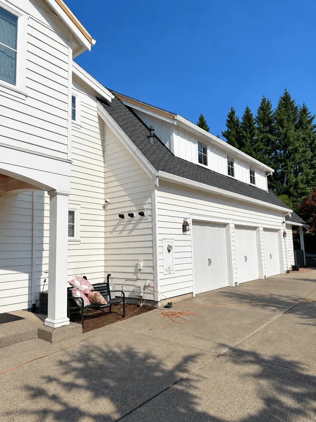 White lap siding across a three-car garage wing