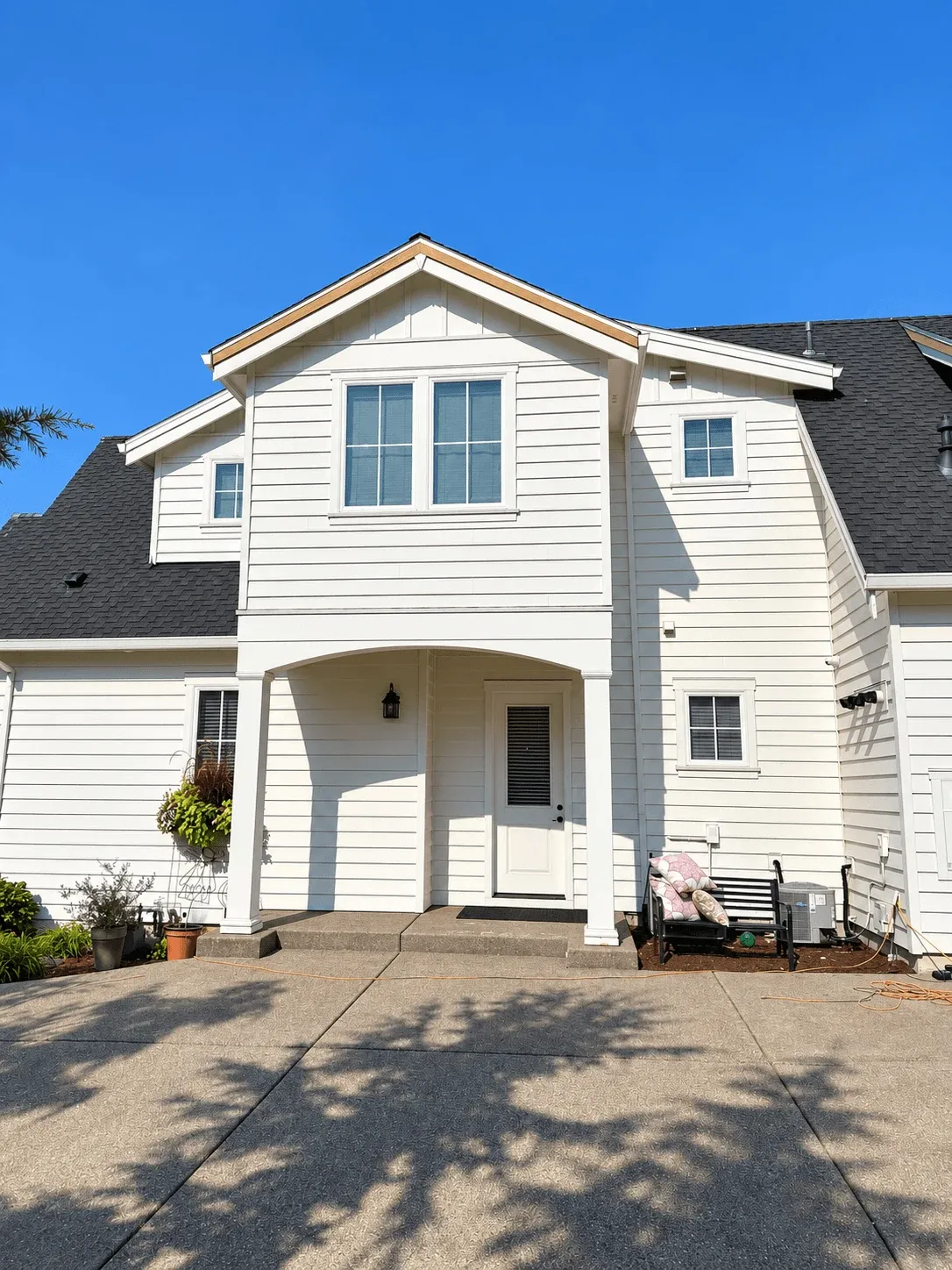 White lap and board-and-batten siding on a two-story entry