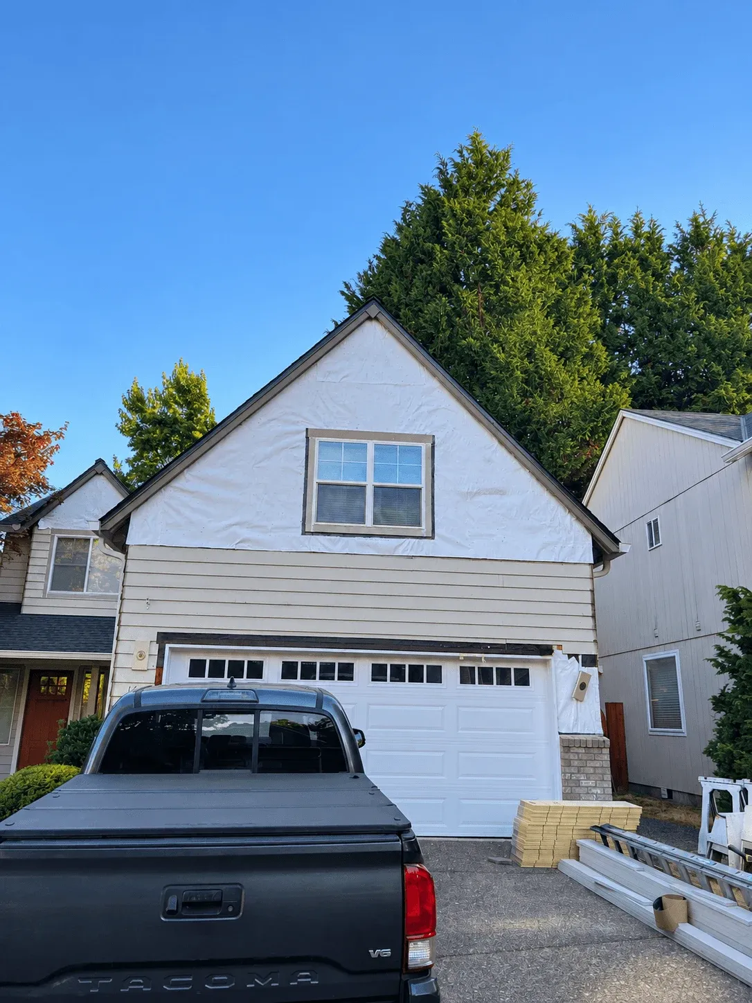 House wrap on a garage gable during siding replacement