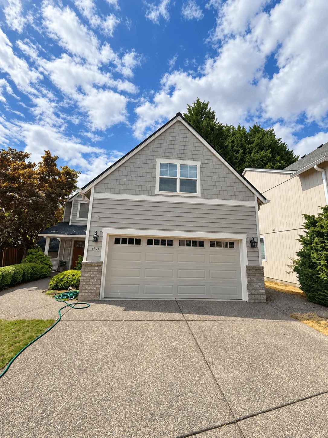 Finished gray siding and shake gable on a two-car garage
